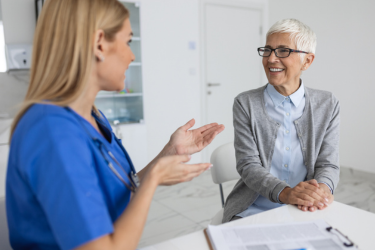 Chiropractor talking to her client