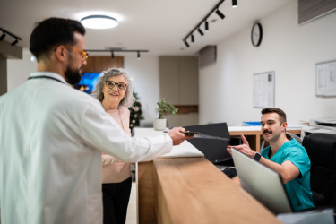 Dr.setting a follow-up appointment for his client.