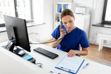 Female medical front desk getting overwhelmed by phone calls