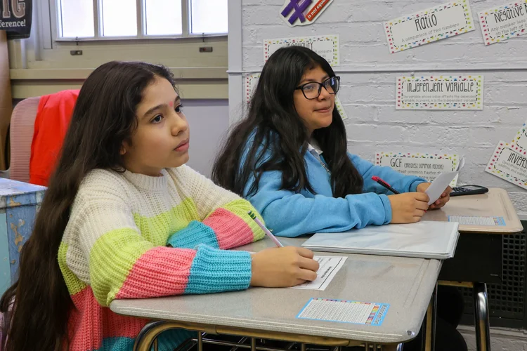 Two middle school students attentively listening during math class