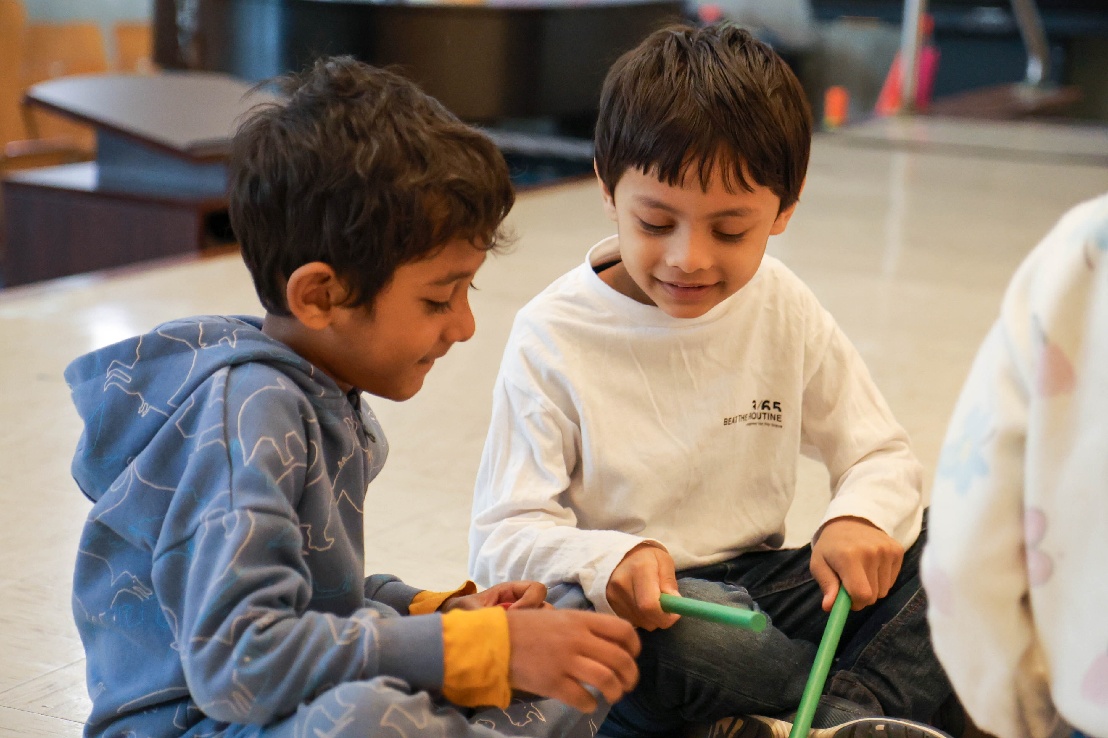 Two young students collaborating on a hands-on classroom activity together
