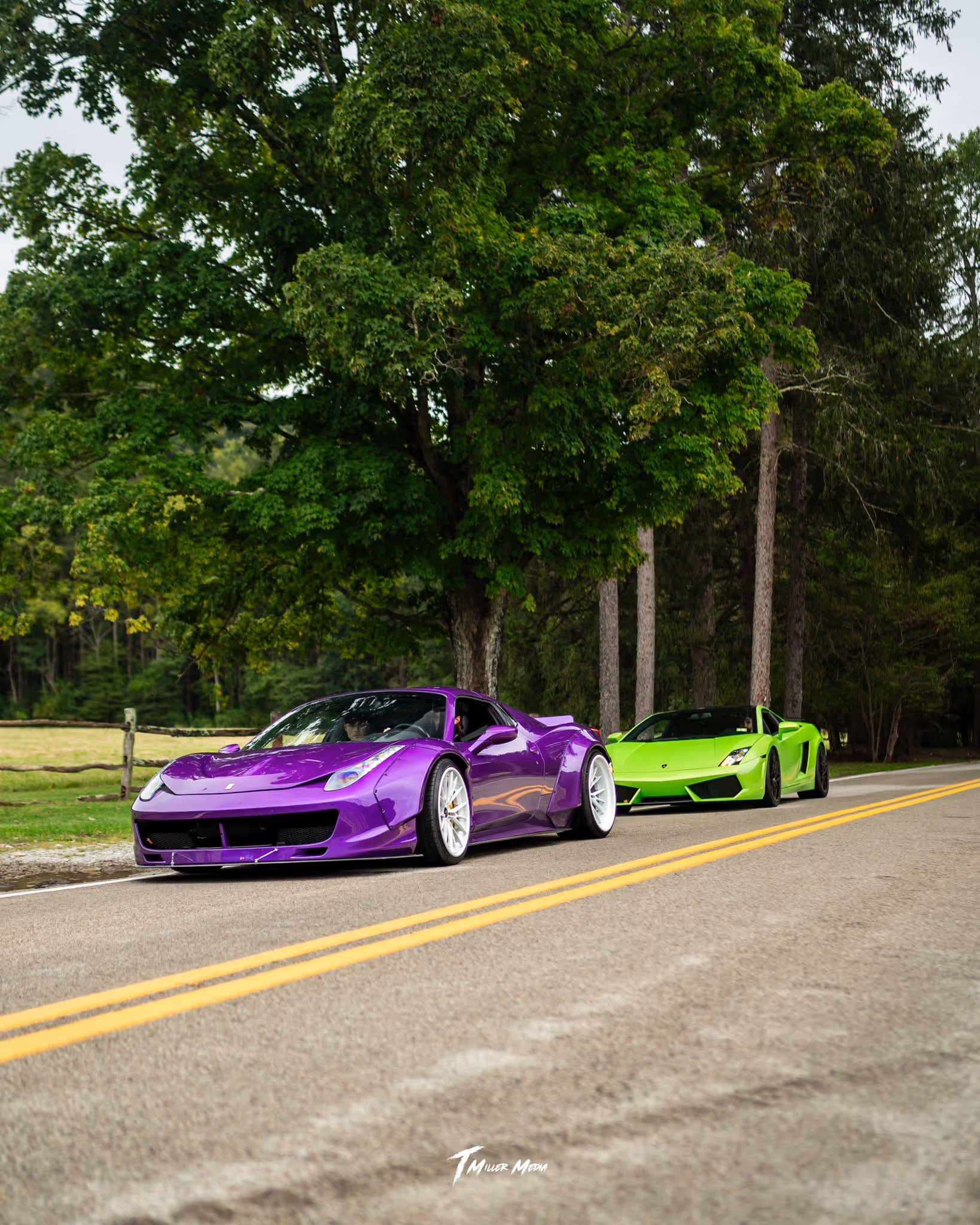Green Lamborghini and purple Ferrari parked on a roadside