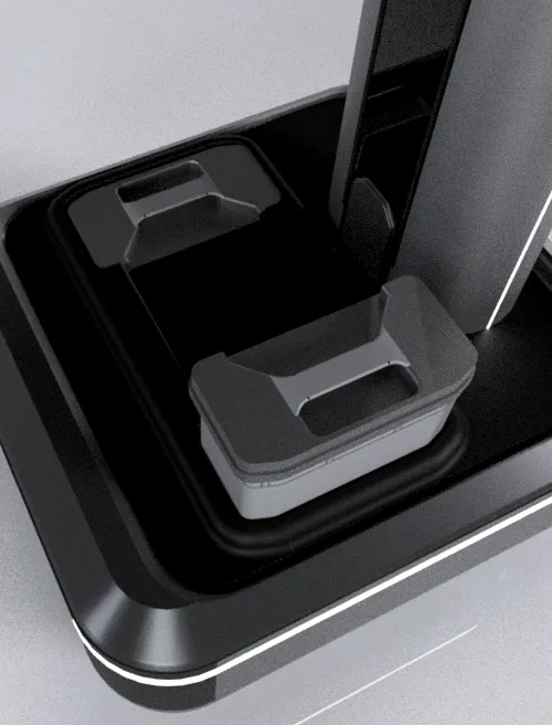 Close-up of a gray and black electronic device base with two rectangular, raised sections.