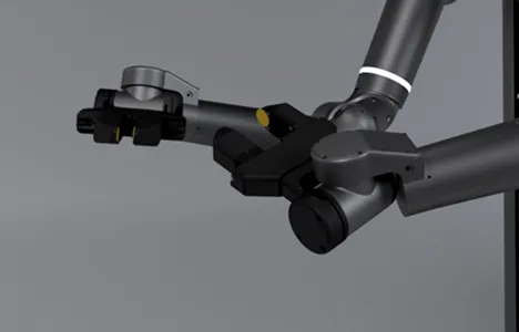 Close-up of a gray robotic arm with a gripping claw against a plain gray background.