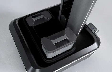 Close-up of a black and gray device with two rectangular containers and a USB port on the side.