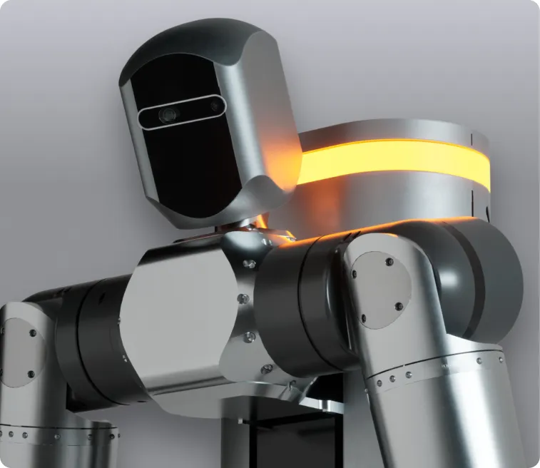 Close-up of a silver and black humanoid robot with a glowing orange light band on its back against a gray background.