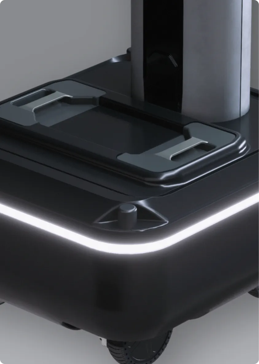 Close-up of a black robotic base with a glowing white light strip and a vertical cylindrical component.