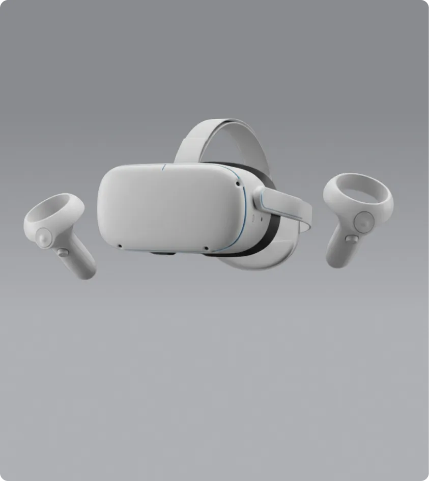 White virtual reality headset with two wireless controllers on a gray background.