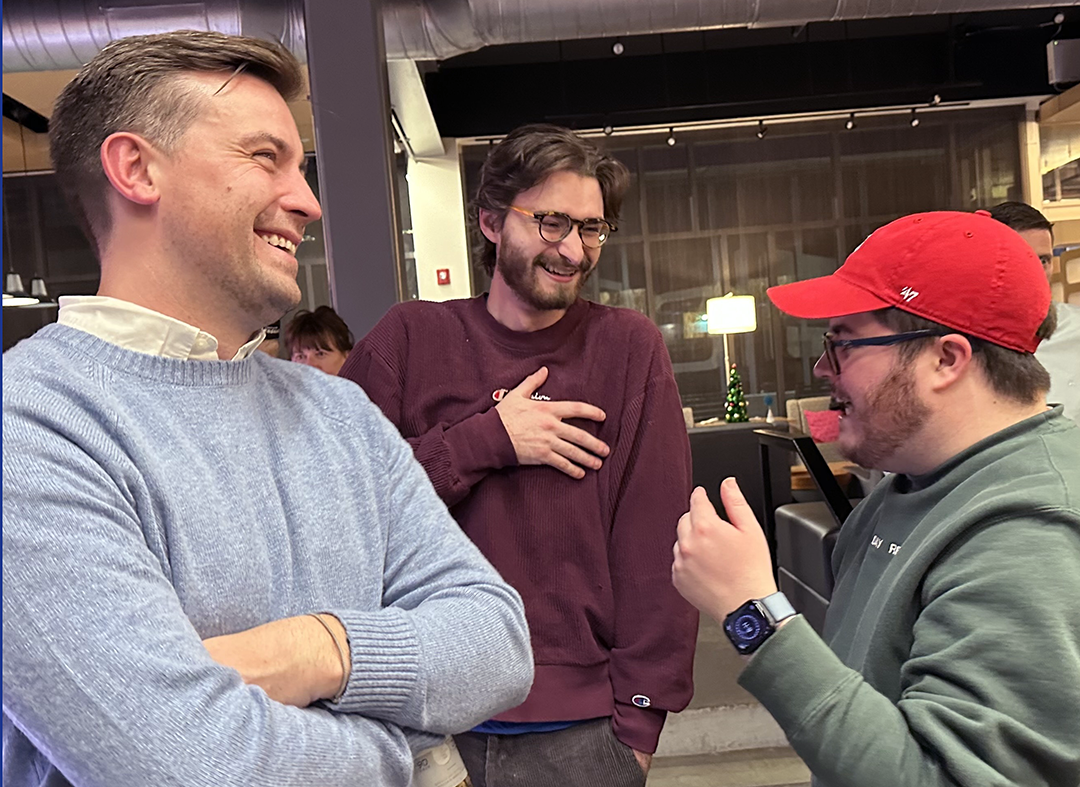 DPLFP colleagues laughing and chatting casually indoors.