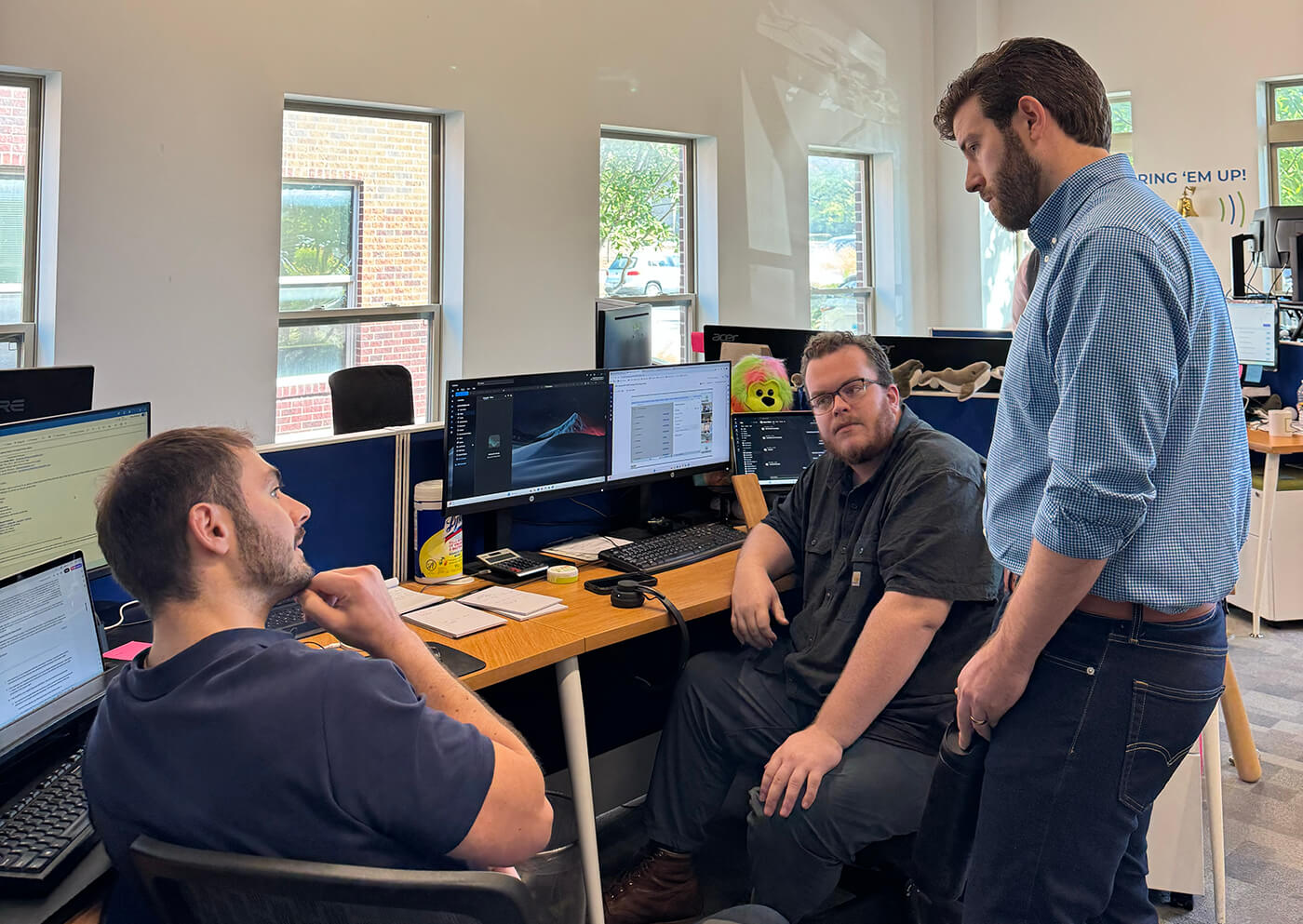 DPLFP coworkers collaborating and talking in the office.