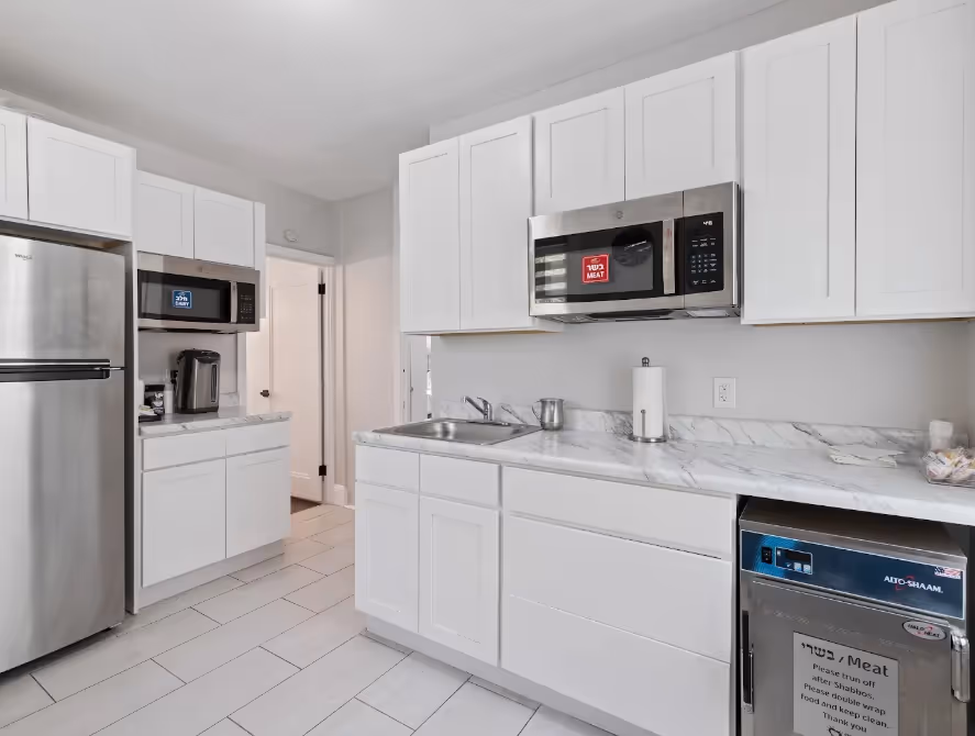 Kosher kitchen inside a Chesed 24/7 hospital apartment, equipped with separate meat appliances and storage for families staying near hospitals