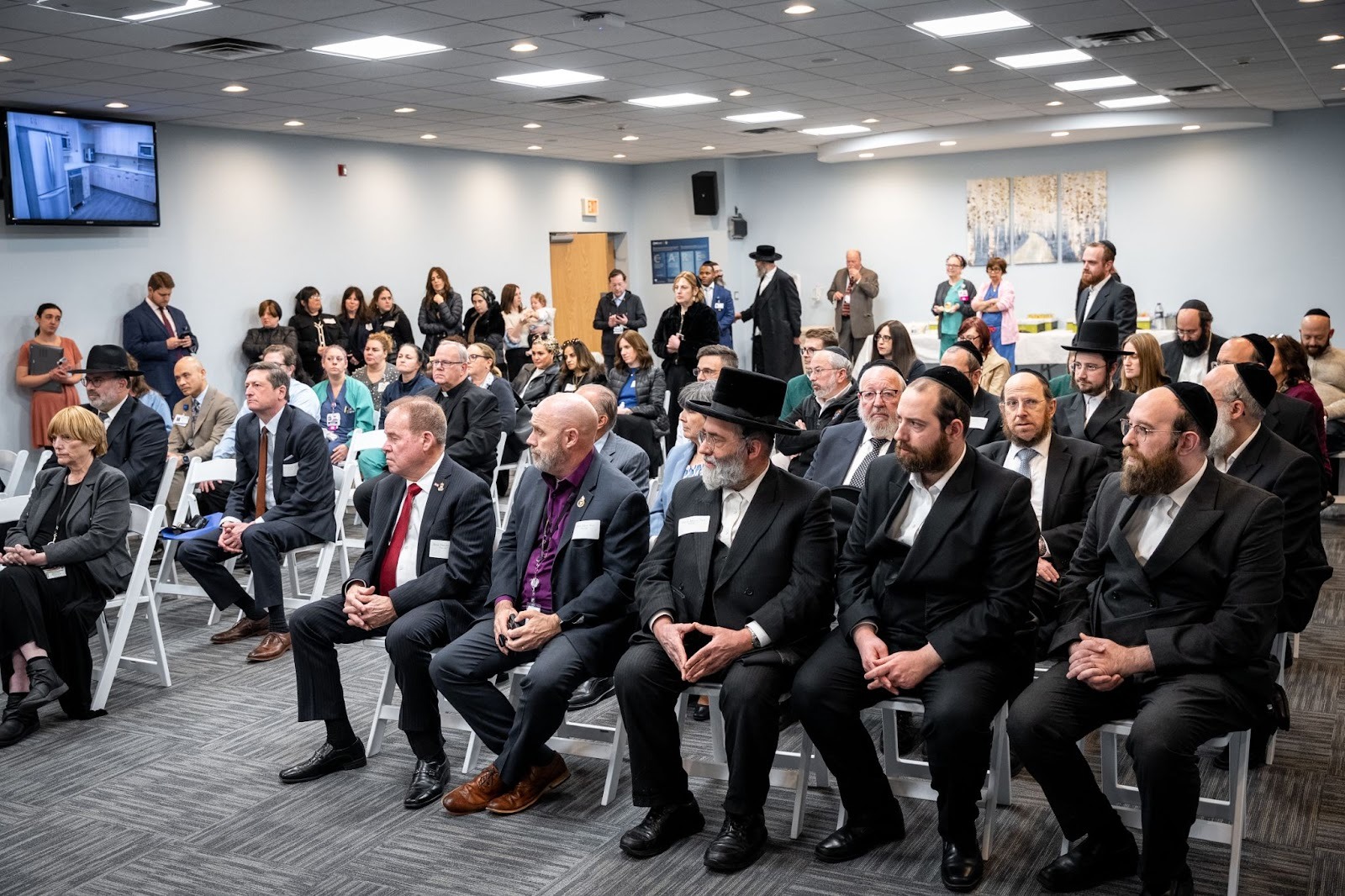 partial view of crowd at ribbon cutting for expanded Good Samaritan chesed room