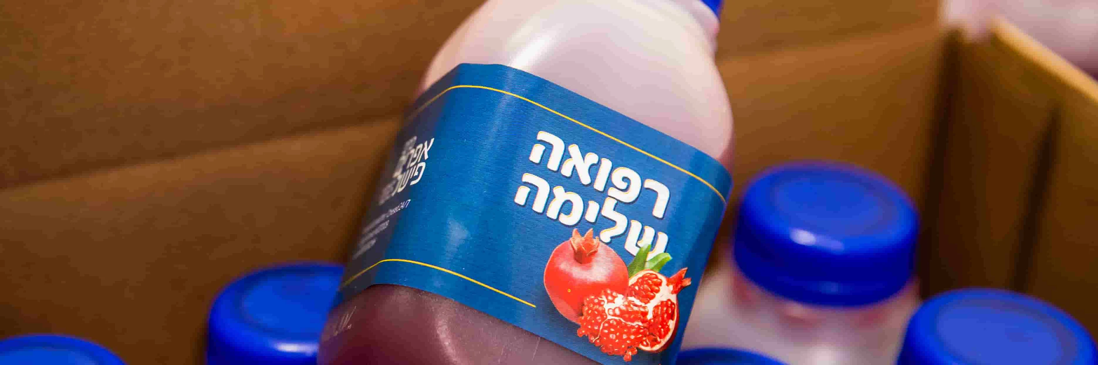 Bottles of pure kosher pomegranate juice from the Chesed 24/7 Boost in a Bottle program
