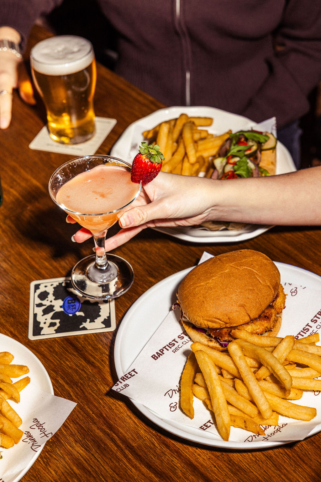 Blue wall with white painted text reading 'SUMMER SALT' and part of a building roof visible on the left.