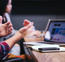 A meeting with a focus to the hands and laptop