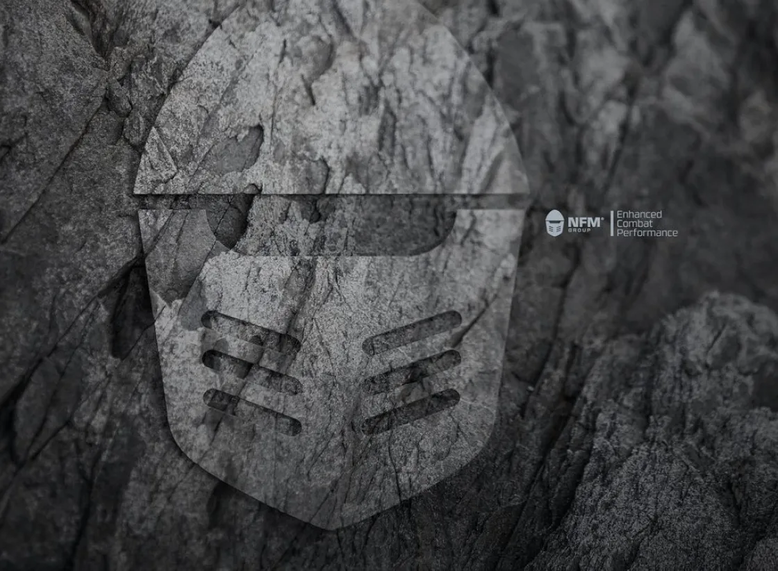 Black and gray textured background with a large semi-transparent helmet graphic and the text 'NFM Group | Enhanced Combat Performance'.