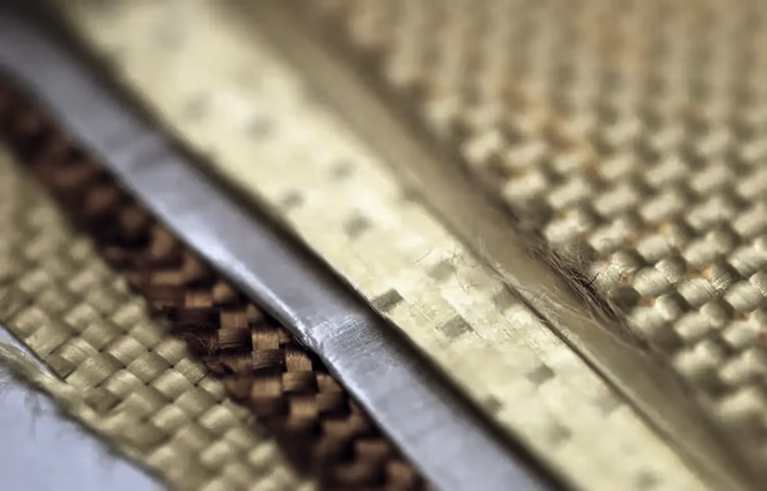 Close-up image of tightly woven fabric with a metallic strip running through the center.