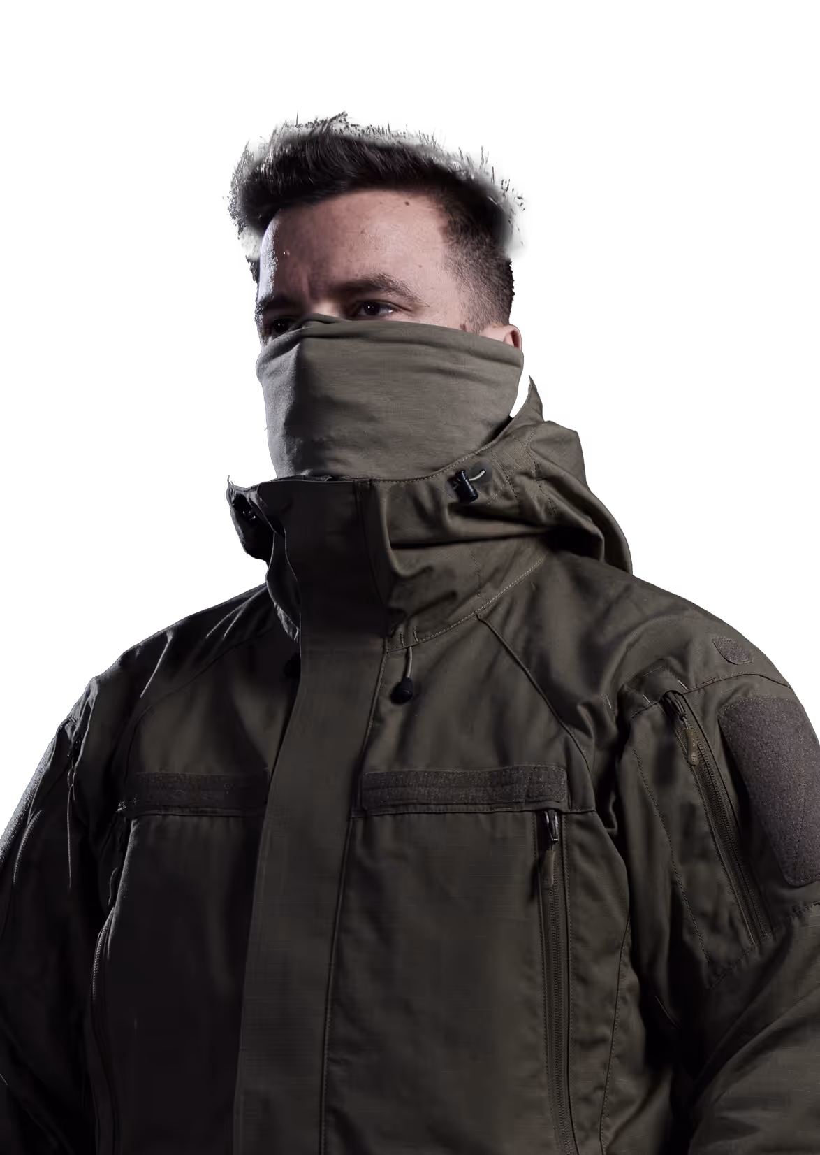 Man wearing an olive green tactical jacket with a high collar covering his neck and mouth, against a black background.