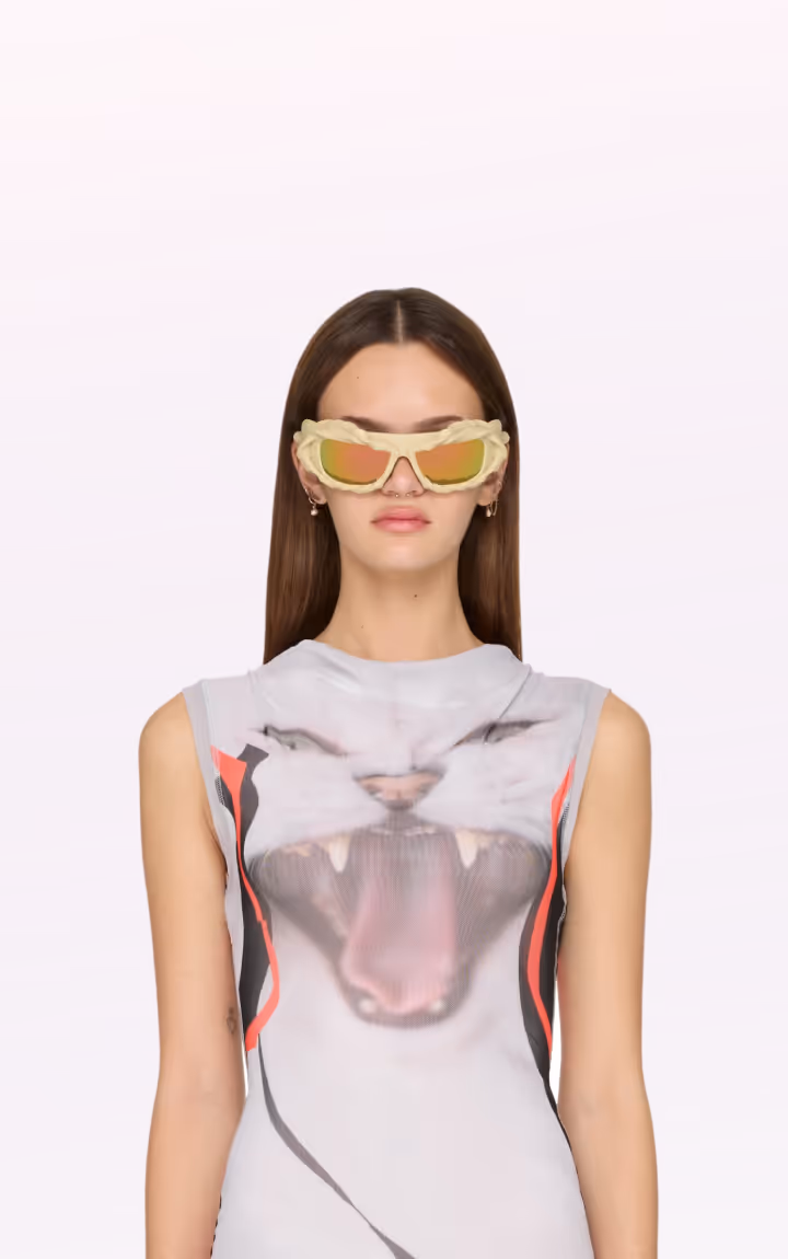 Model in yellow sunglasses with cat face graphic top.