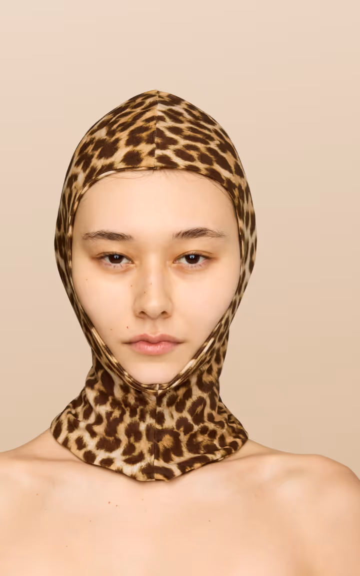 Model wearing leopard print head covering