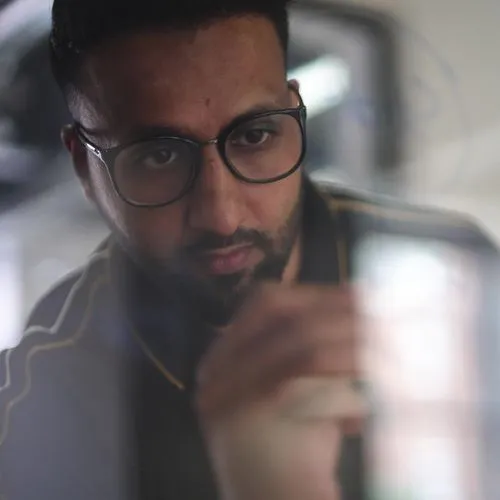 Photograph of team member sketching ideas on glass wall