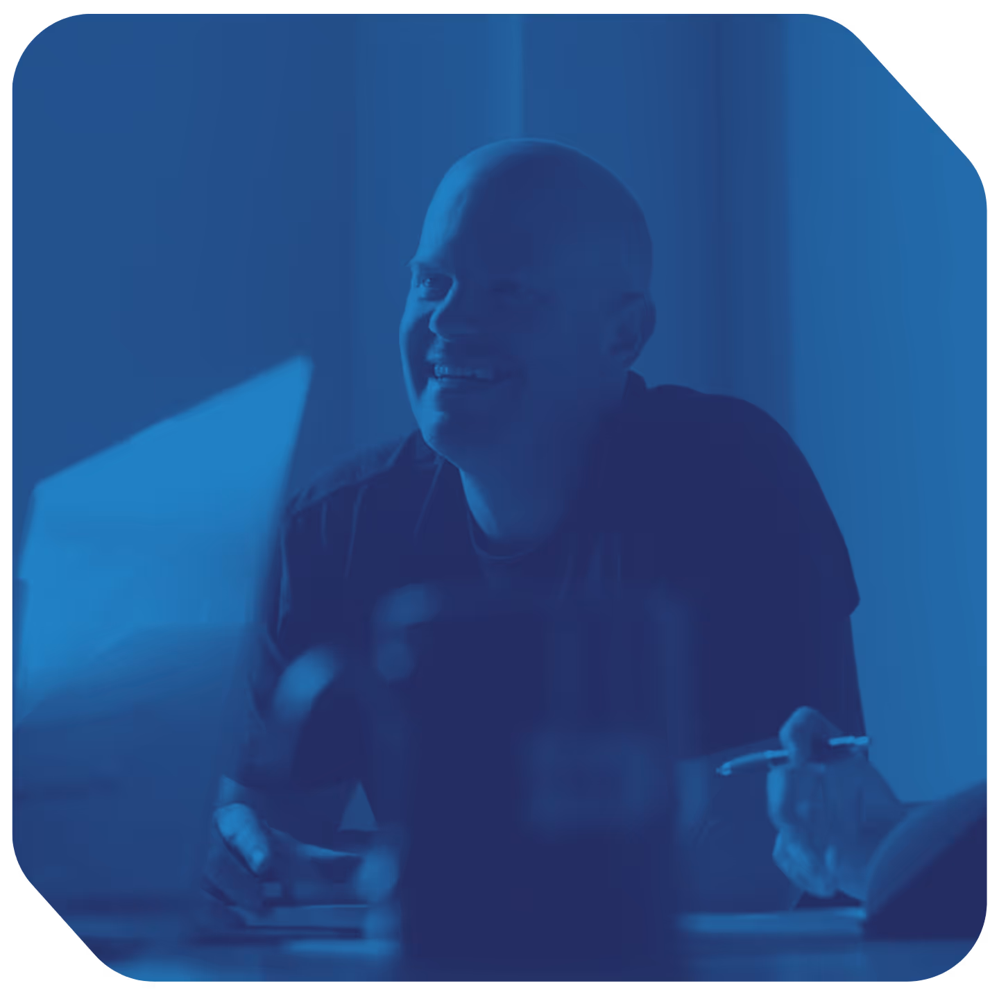 a man smiling at a computer