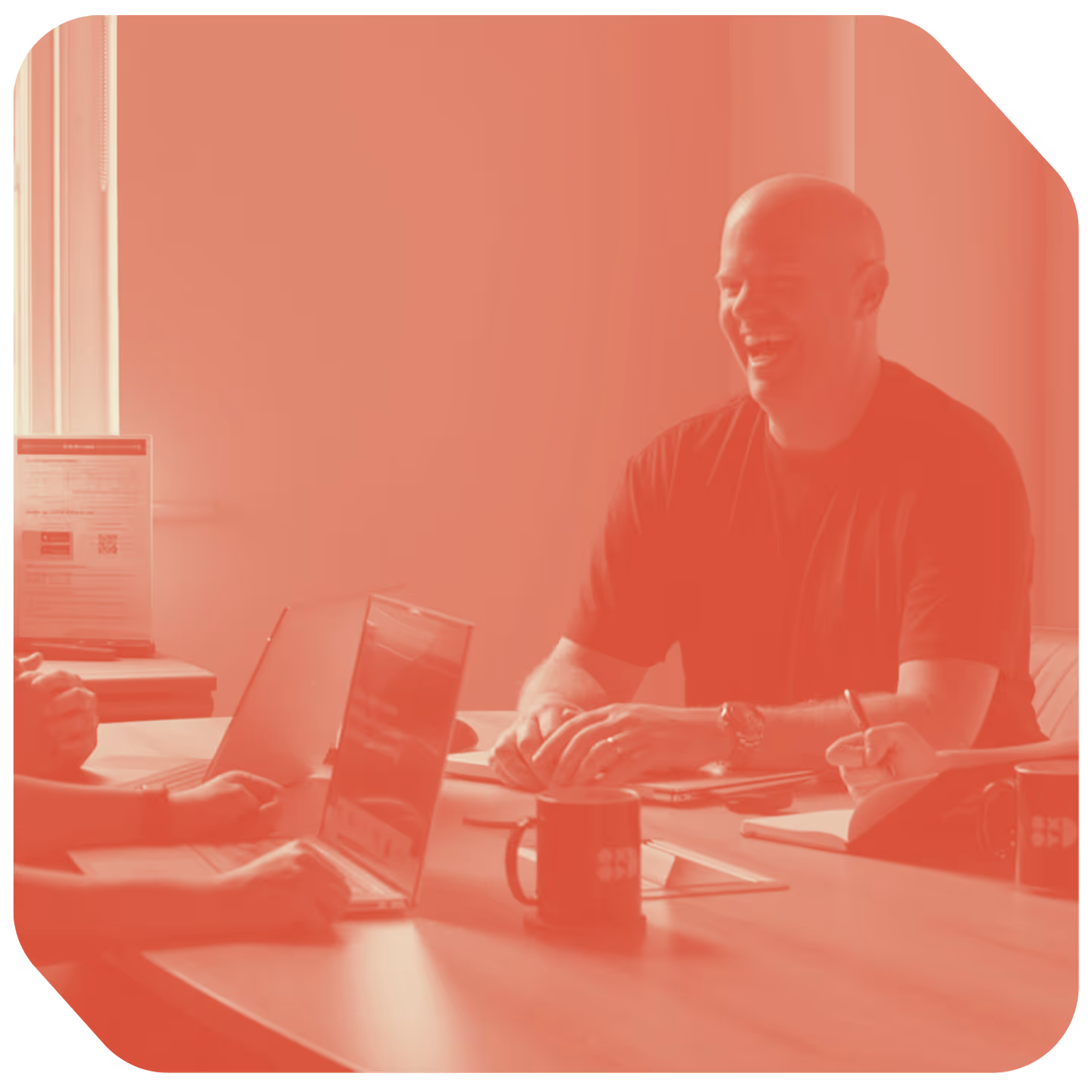 a man sitting at a table with a laptop and a woman sitting at a table