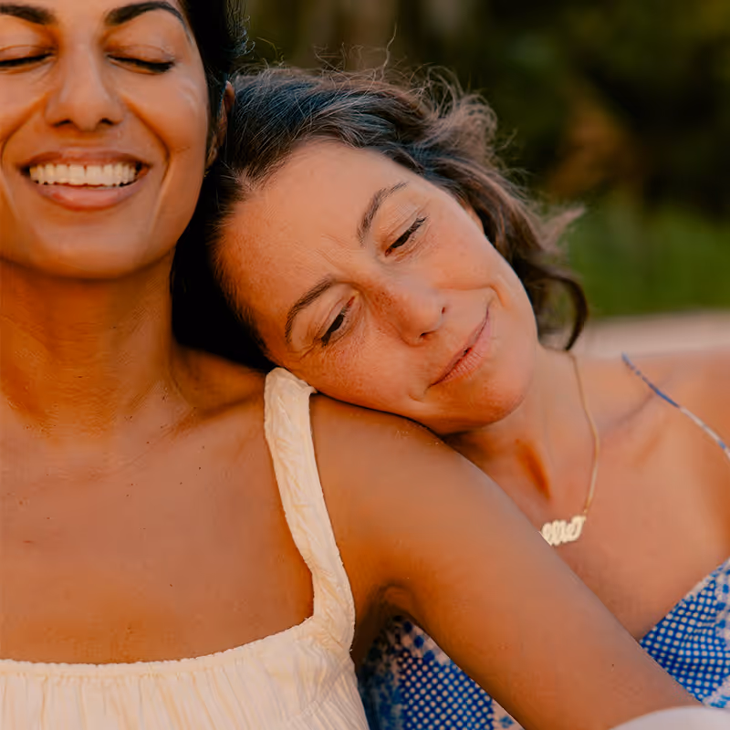 Two women sharing a tender moment. Clean Slate Clinic client.