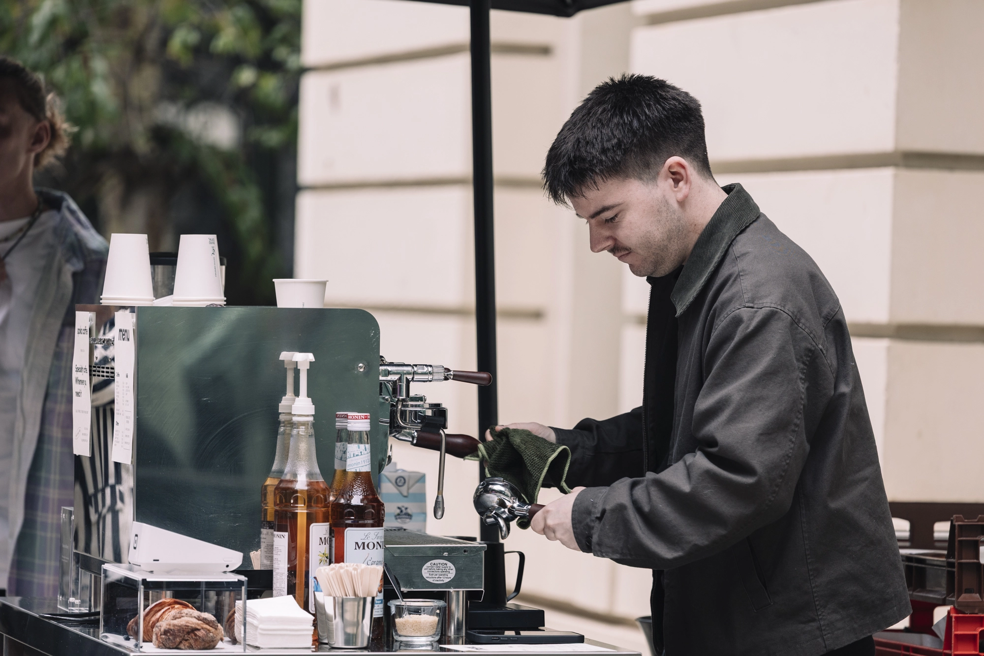 Barista serving coffee at a spoko coffee cart