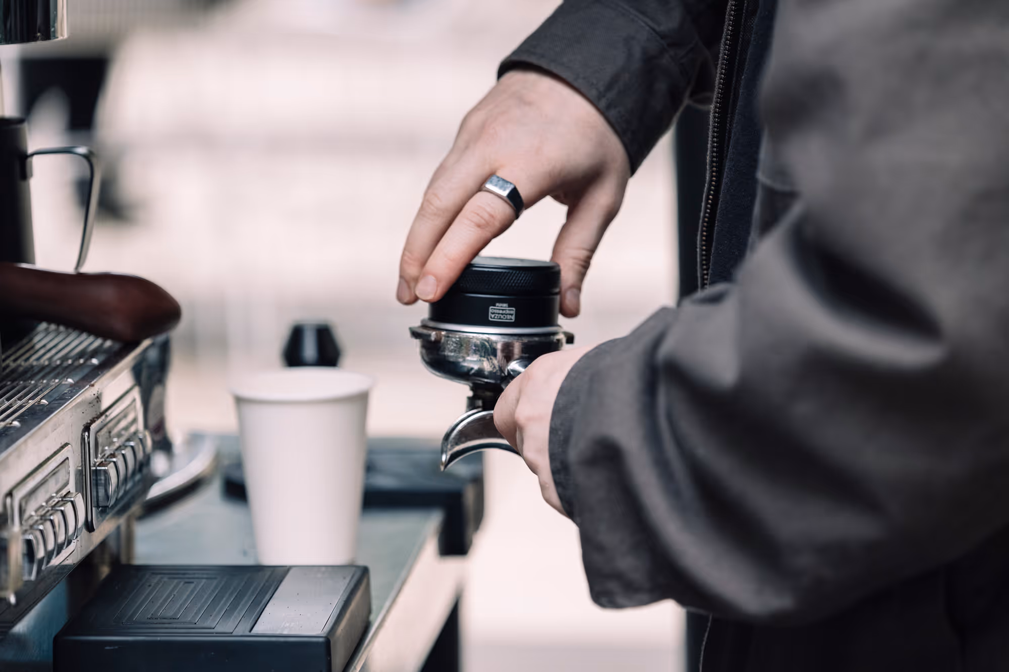 barista tamping a coffee puck at a spoko coffee cart