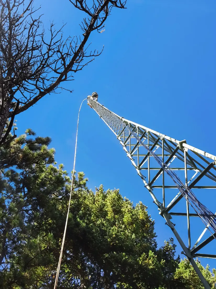 Tower technician climbing in winter