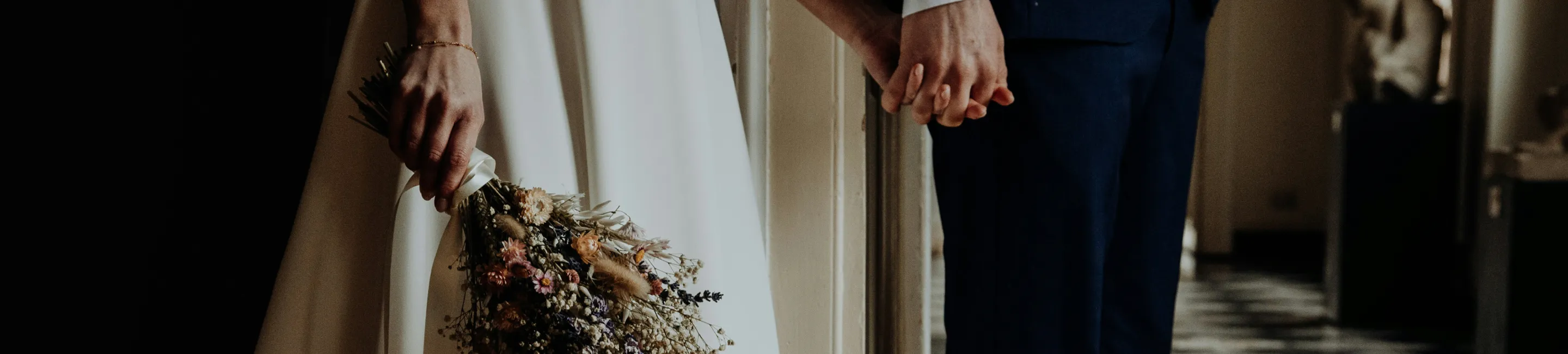 A bride and a groom holding hands.