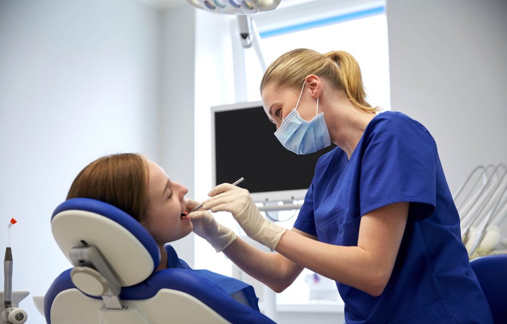 Dentist 33317 studying patients mouth