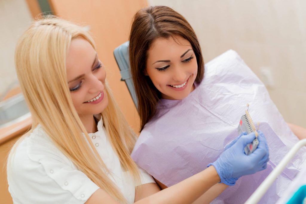 Dentist and patient seeing implants diagram in Fort Lauderdale, FL