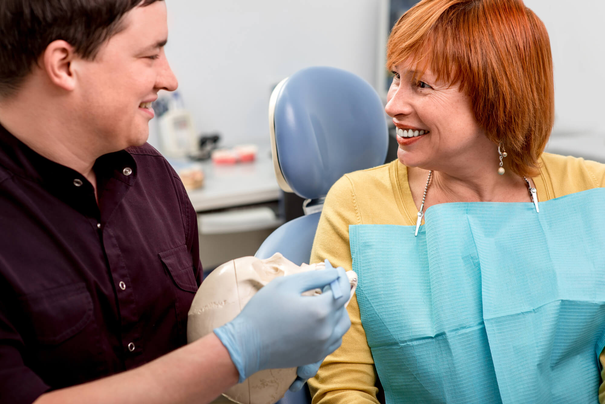 a dentist discussing metal Dental Crowns in Davie, FL 
