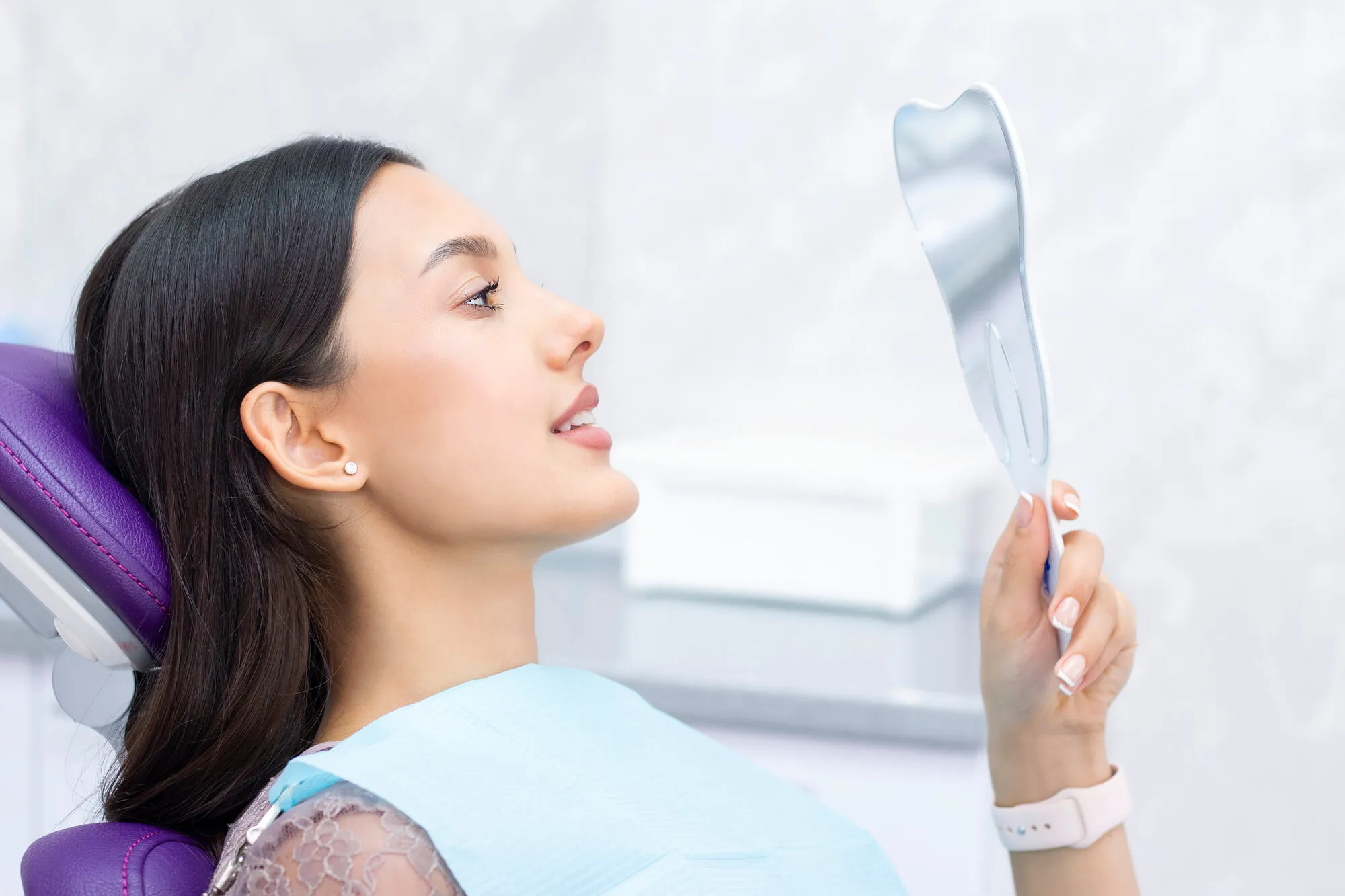 Patient at a dental office looking at the mirror after an extractions in Plantation,Ffl