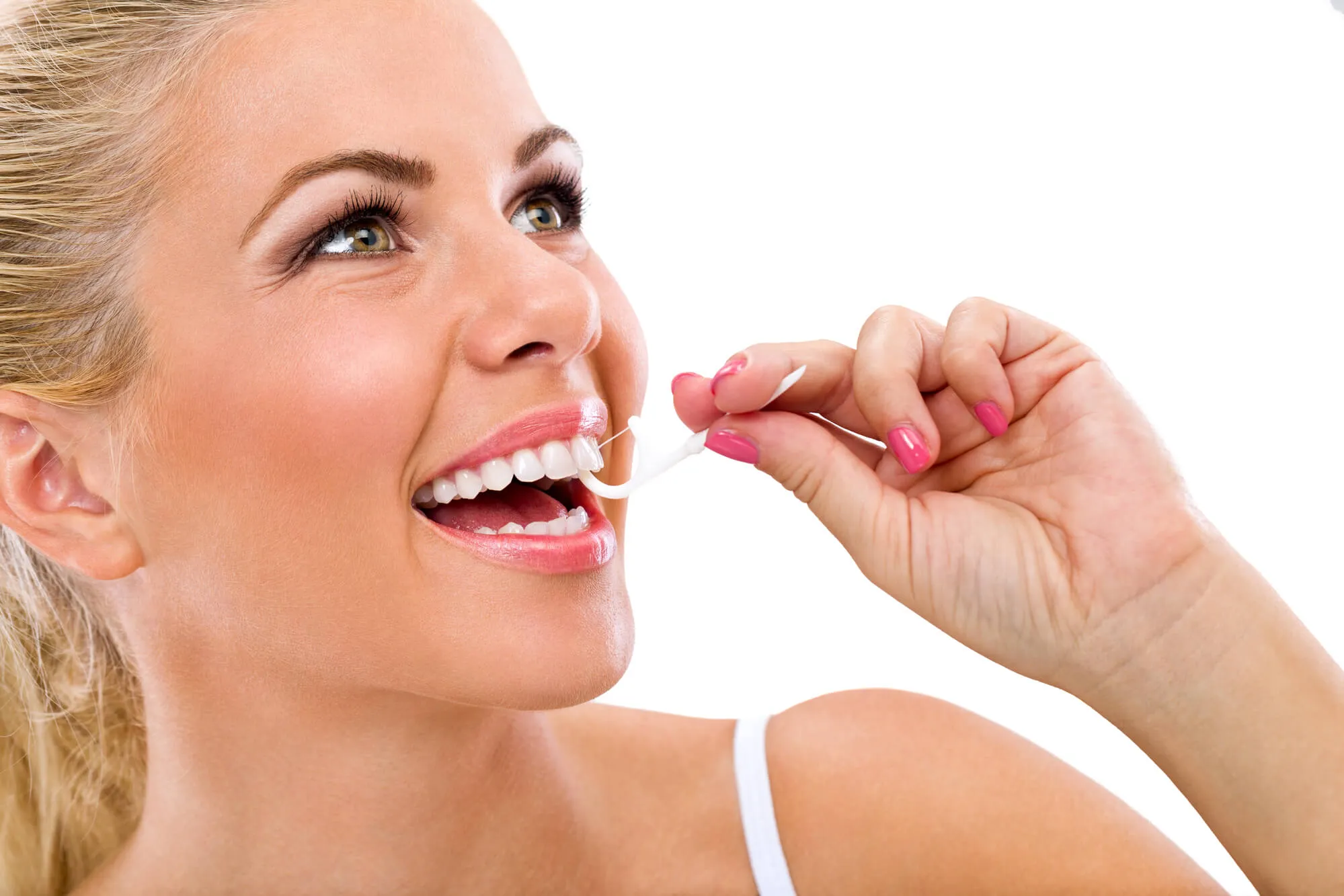 Woman flossing her teeth after a cosmetic dentistry procedure in Davie, Fl