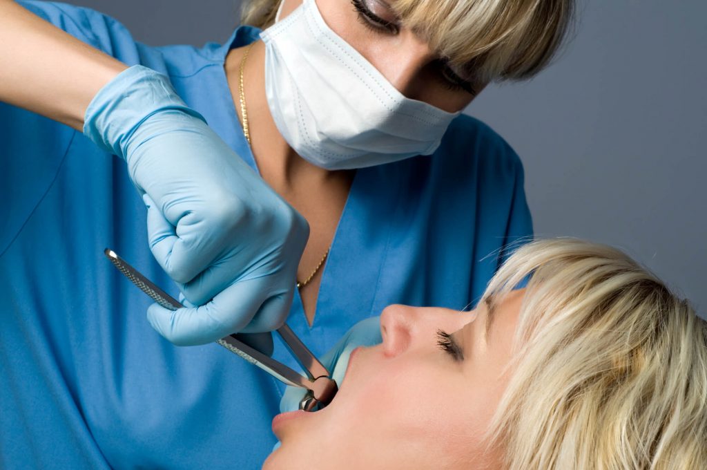 Woman having a tooth pulled