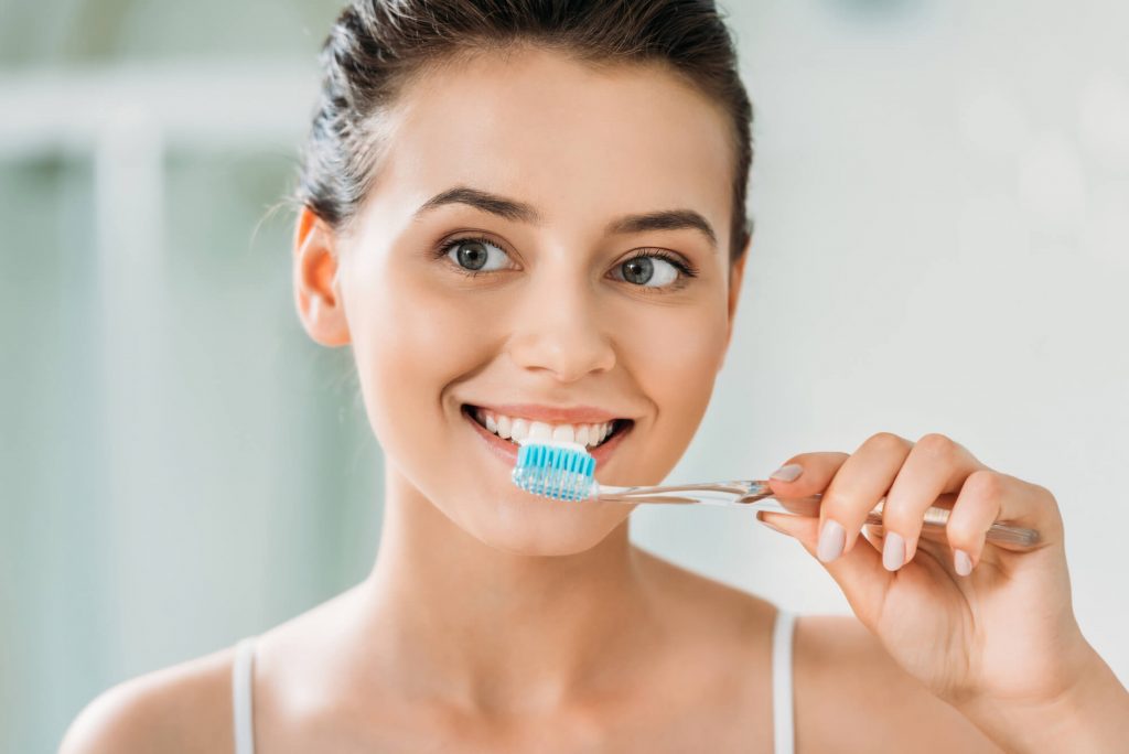woman performing teeth cleaning in 33317