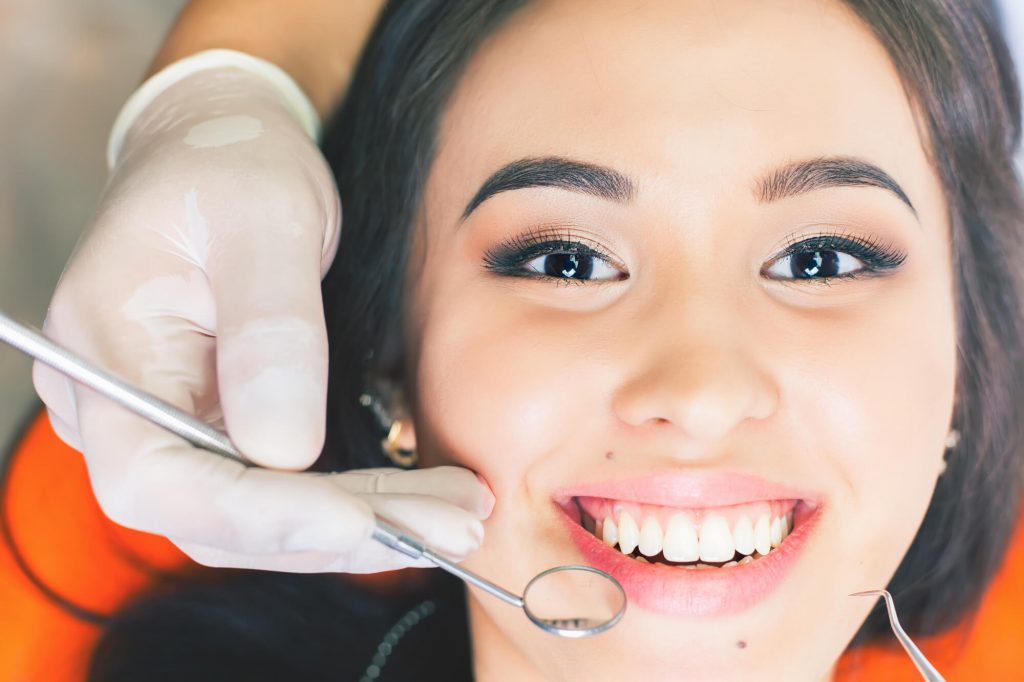 woman-smiling-while dentist-is-checking-family-dentistry-33313