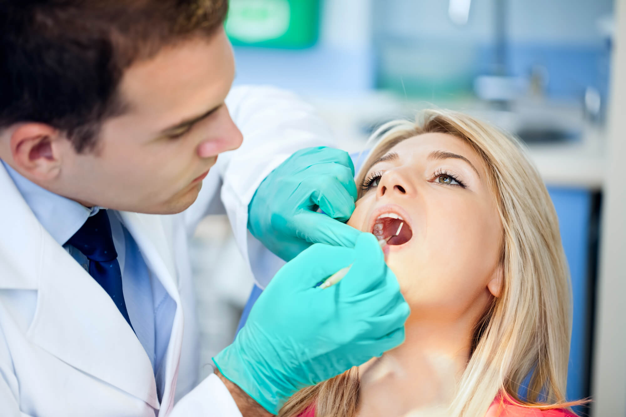 a dentist at a dental office in plantation fl examining a patient