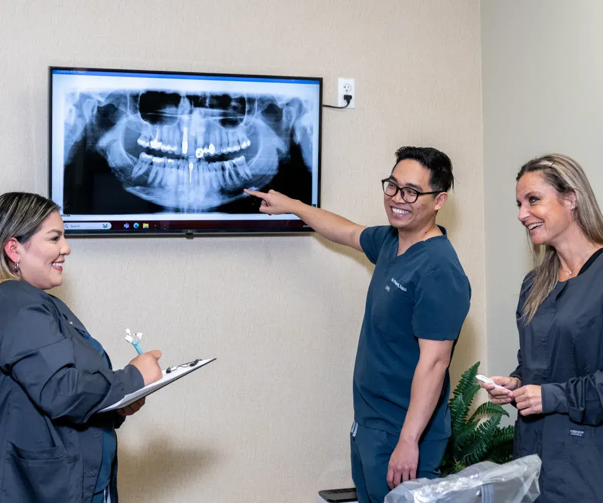 Dentist looking at a X-ray image on a tv screen