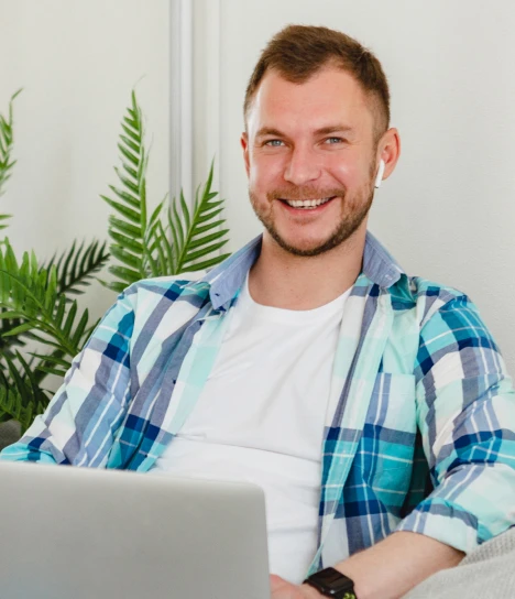 a man sitting in front of a laptop computer