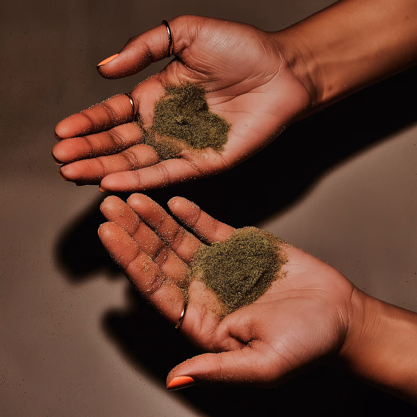 Hands Holding green Matcha powder.