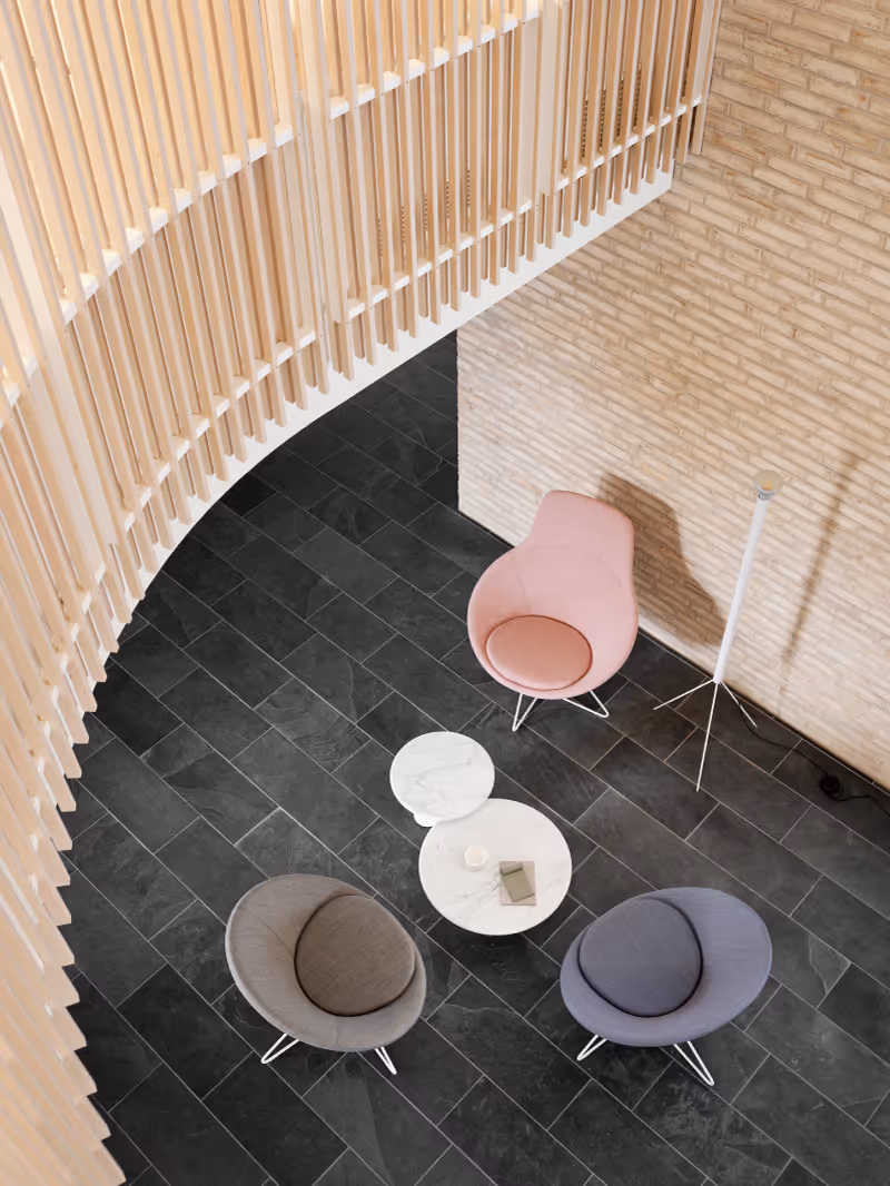 Top view of a modern lounge area with three cushioned chairs around two round white marble tables on dark tile floor under a curved wooden slatted structure.