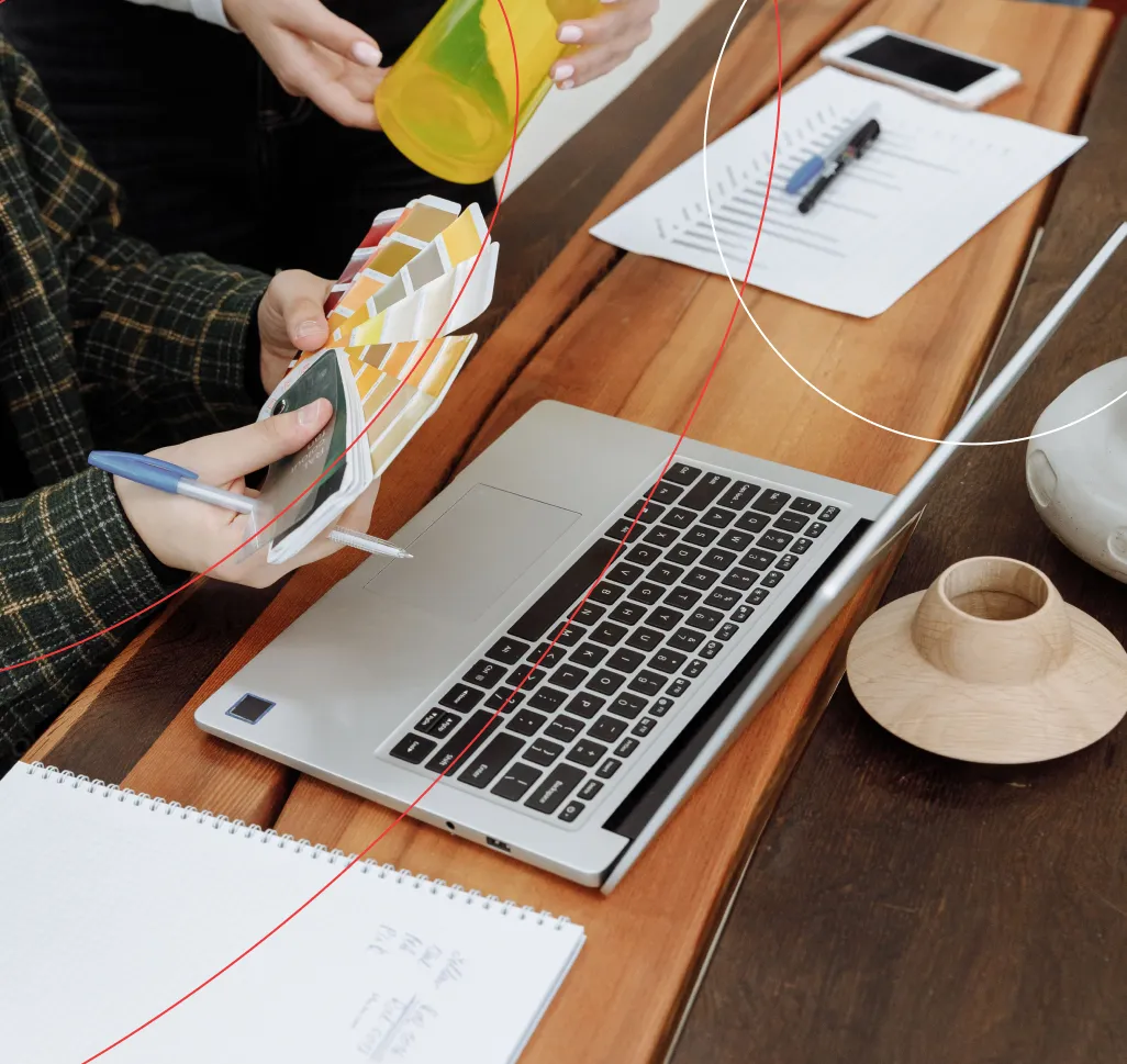 Designer choosing colour swatches at a laptop — XCL Labs culture