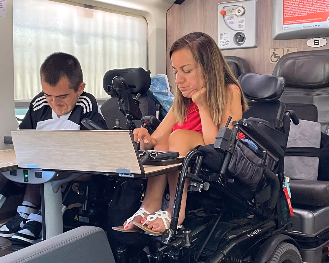 Natalie Russo and Jordan Dickey sitting on a train in Italy