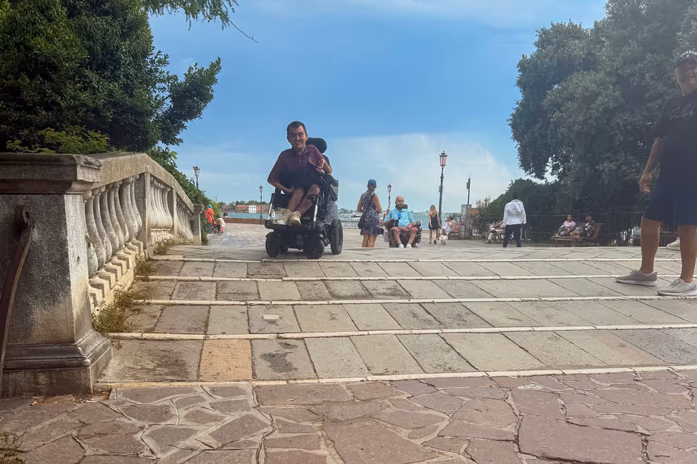 Man in wheelchair on top of brick ramp in Venice, Italy