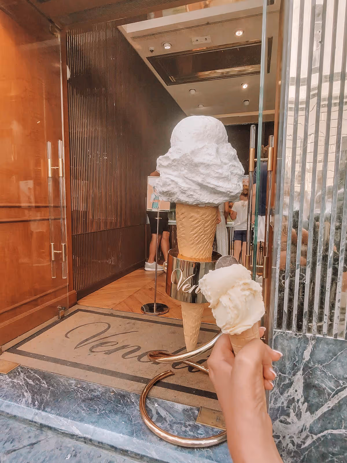 Holding a gelato cone in front of venchi