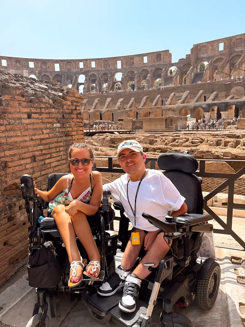 Natalie and Jordan posing for a photo inside the Roman Colosseum